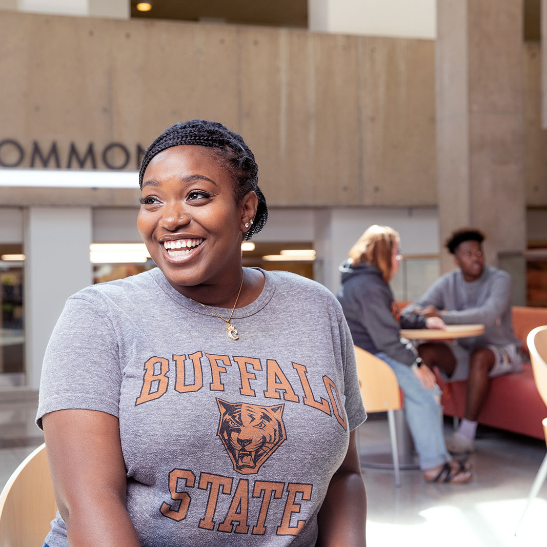 Female student sitting in a chair in the library